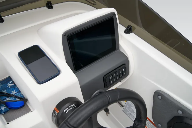 Slide: The Image of Manufacturer Provided Image: Dashboard of 2025 Tahoe T21 boat with steering wheel and digital display. - 33