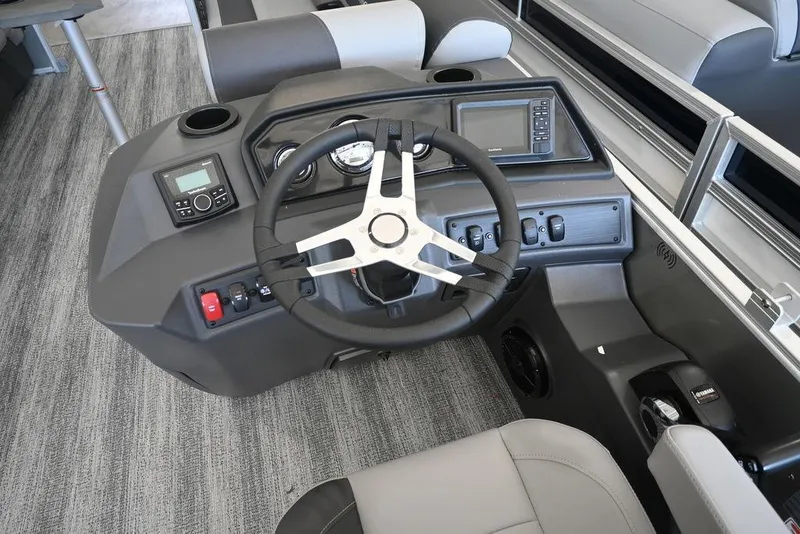 Slide: The Image of 2026 Bennington S Quad Bench 21 SSR boat dashboard with steering wheel and controls. - 11