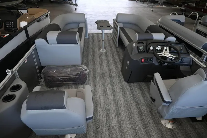 Slide: The Image of 2026 Bennington S Quad Bench 21 SSR interior with gray seating and modern helm. - 12