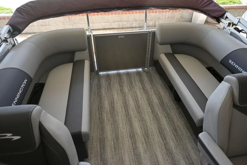 Slide: The Image of 2026 Bennington S Quad Bench 21 SSR interior with gray seating and carpeted floor. - 6
