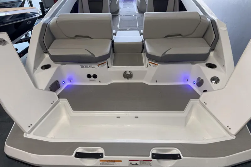 Slide: The Image of 2026 Scarab 255 SE boat interior with gray seating and ambient blue lighting. - 13
