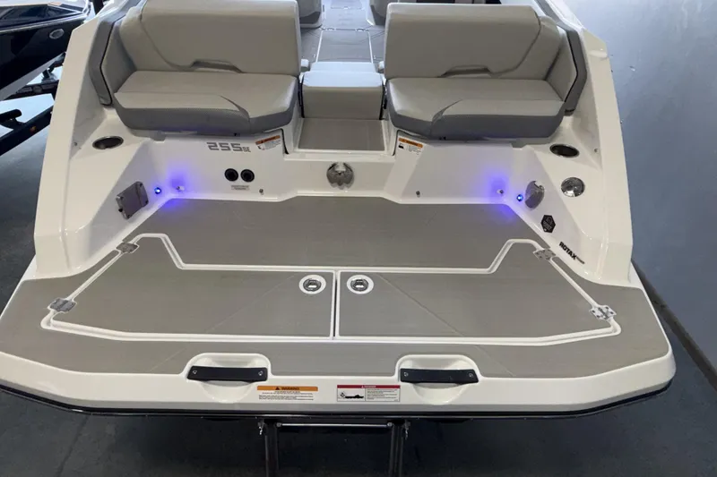 Slide: The Image of 2026 Scarab 255 SE boat rear view with seating and deck lighting. - 14