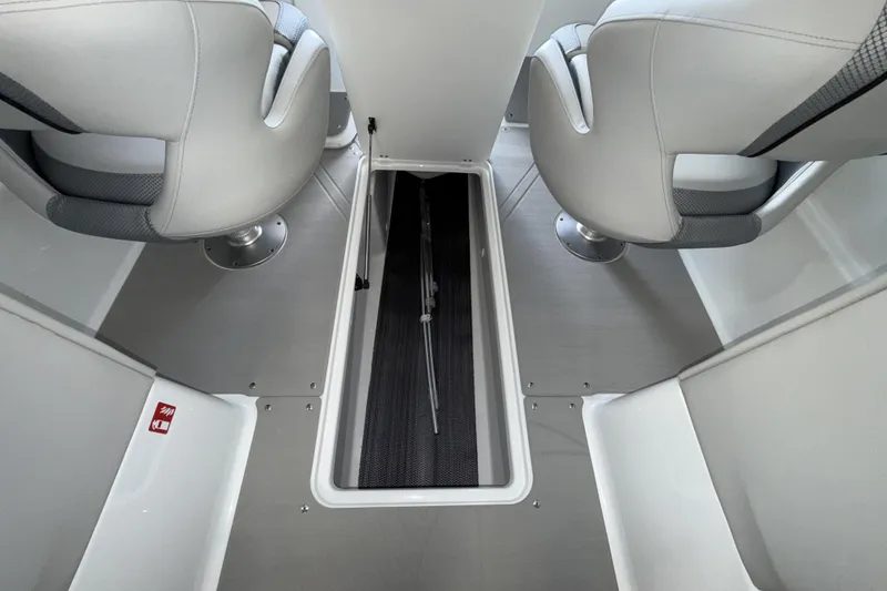 Slide: The Image of Interior view of 2026 Scarab 255 SE boat, featuring sleek seating and storage compartment. - 17