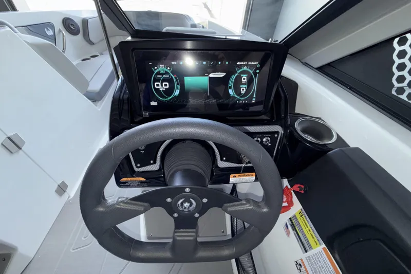 Slide: The Image of Cockpit of 2026 Scarab 255 SE boat with digital dashboard and steering wheel. - 21