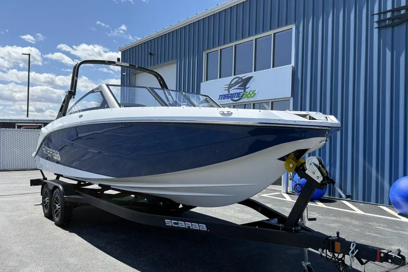 Slide: The Image of 2026 Scarab 255 SE boat on trailer outside Marine 365 building. - 4