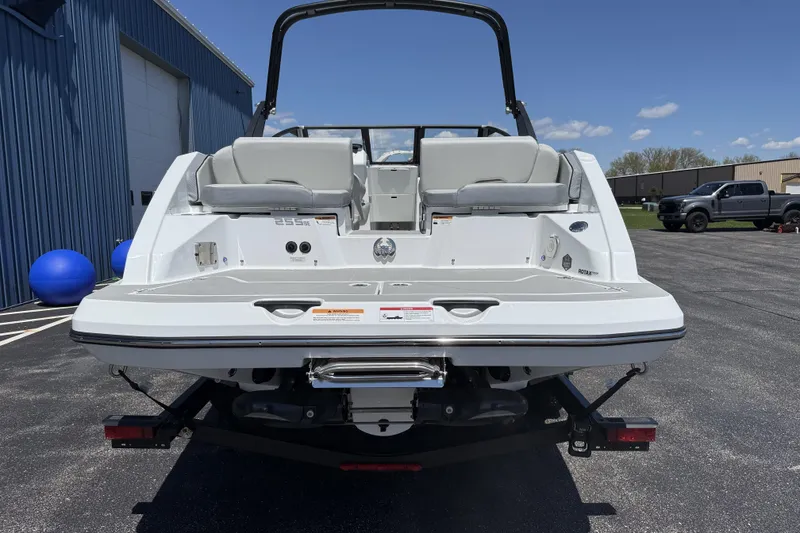 Slide: The Image of 2026 Scarab 255 SE boat rear view, parked outdoors on a sunny day. - 5