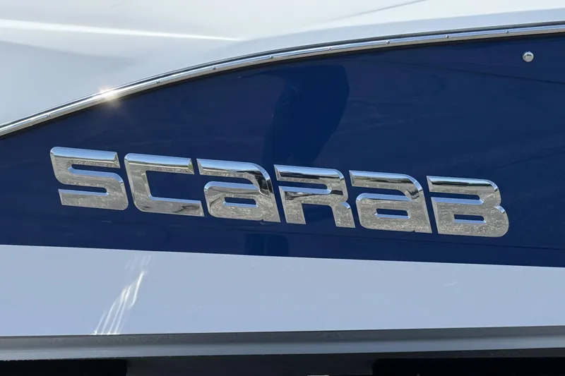 Slide: The Image of Chrome "Scarab" logo on a 2026 Scarab 255 SE boat. - 7