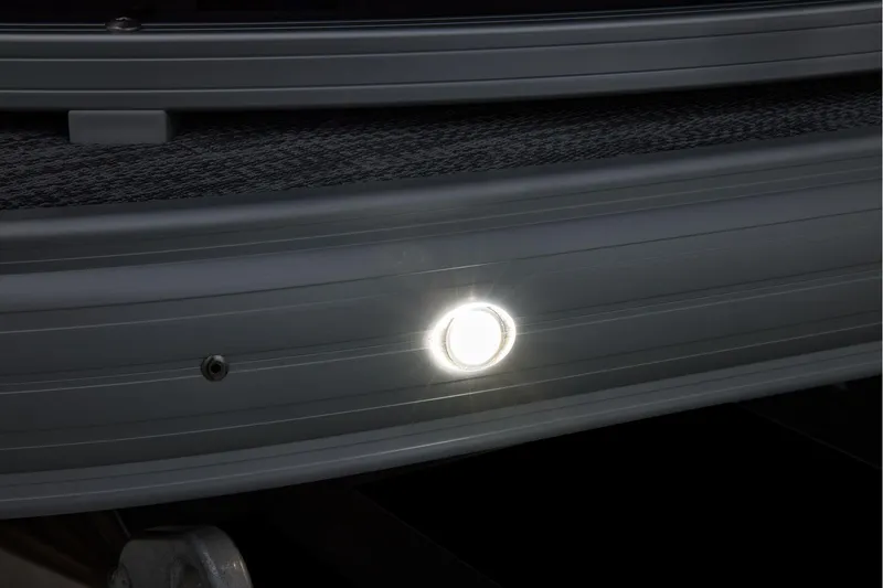 Slide: The Image of Manufacturer Provided Image: 2026 Sun Tracker SportFish 20 DLX boat with illuminated exterior light detail. - 21