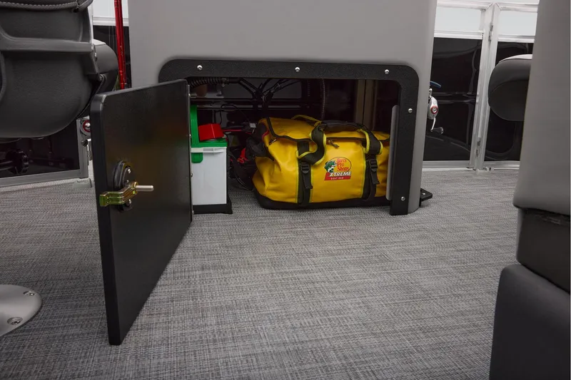 Slide: The Image of Manufacturer Provided Image: 2026 Sun Tracker SportFish 20 DLX storage compartment with yellow bag and equipment. - 59