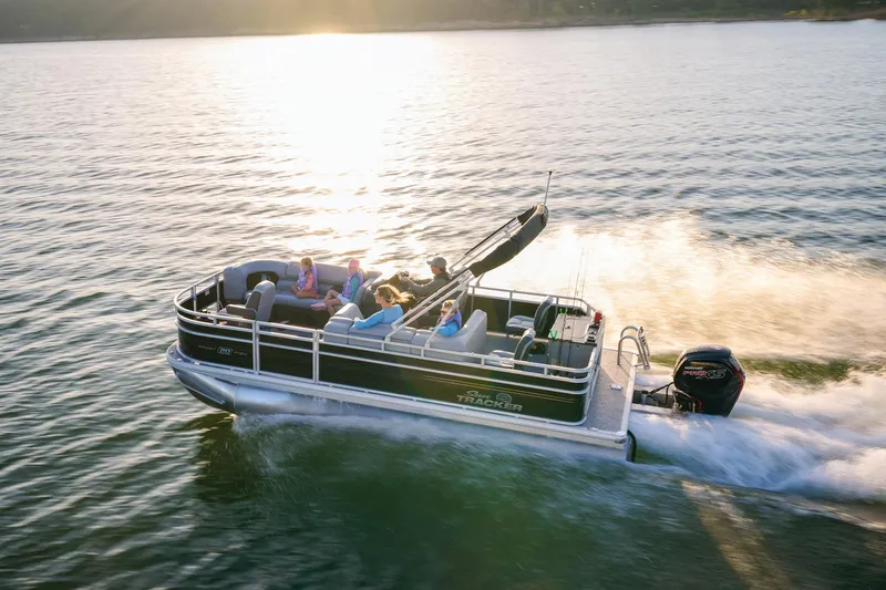 Slide: The Image of Manufacturer Provided Image: 2026 Sun Tracker SportFish 20 DLX pontoon boat cruising on a sunny lake. - 72