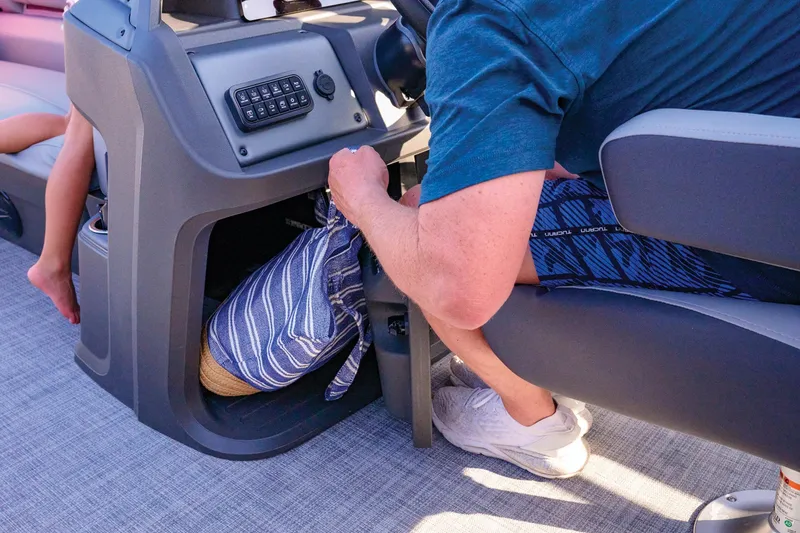 Slide: The Image of Manufacturer Provided Image: Man storing items in Sun Tracker SportFish 20 DLX boat compartment, 2026 model. - 79