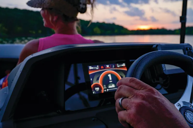 Slide: The Image of Manufacturer Provided Image: 2026 Sun Tracker SportFish 20 DLX dashboard view at sunset on a serene lake. - 83
