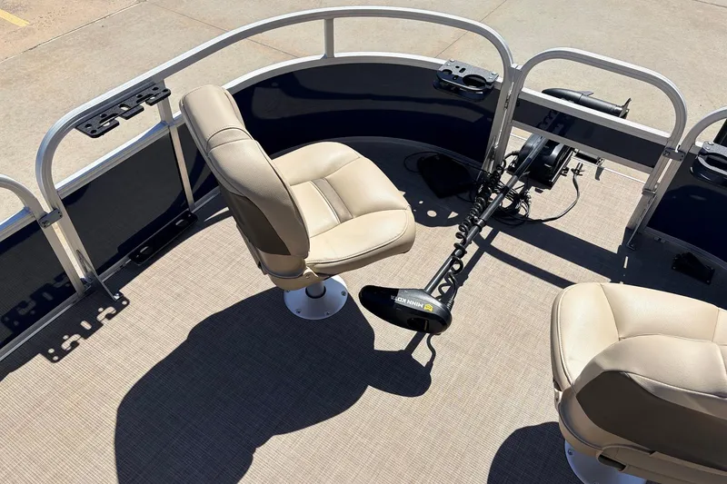 Slide: The Image of 2021 Sun Tracker Bass Buggy 16 XL pontoon boat interior with beige seats and trolling motor. - 14