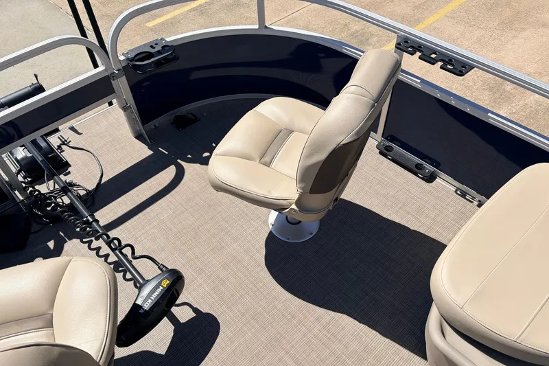 Slide: The Image of 2021 Sun Tracker Bass Buggy 16 XL pontoon boat interior with beige seating and trolling motor. - 15