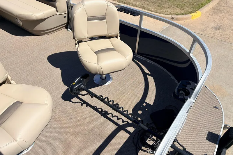 Slide: The Image of 2021 Sun Tracker Bass Buggy 16 XL pontoon boat with beige seating and trolling motor. - 16