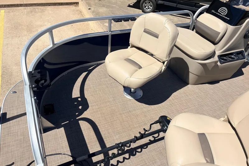 Slide: The Image of 2021 Sun Tracker Bass Buggy 16 XL pontoon boat interior with beige seating and steering console. - 17