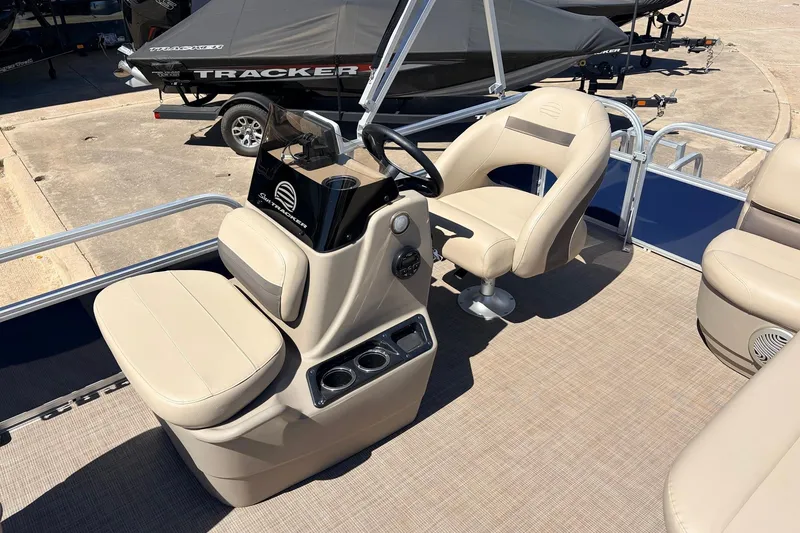 Slide: The Image of 2021 Sun Tracker Bass Buggy 16 XL interior with beige seating and steering console. - 19