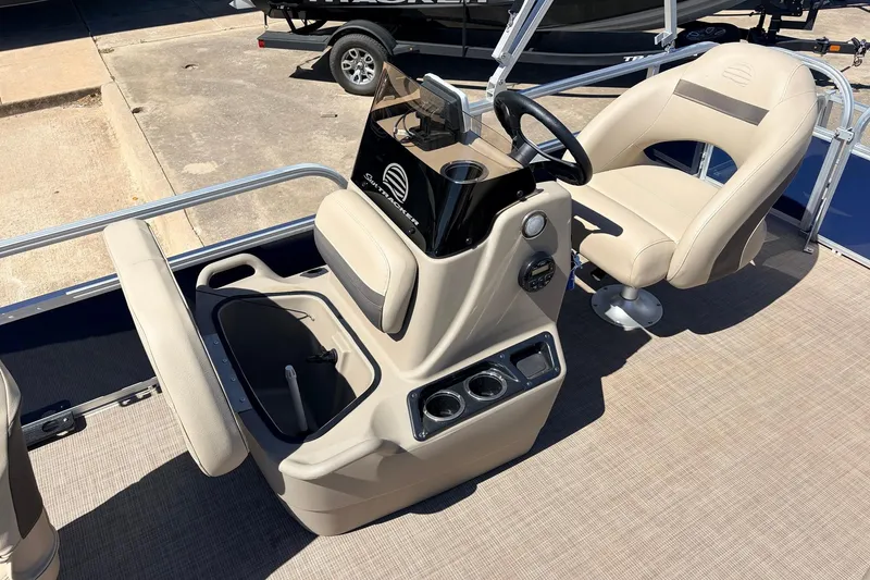 Slide: The Image of 2021 Sun Tracker Bass Buggy 16 XL interior with beige seating and steering console. - 20
