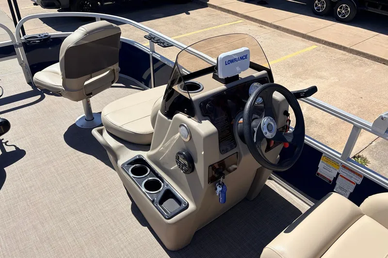 Slide: The Image of 2021 Sun Tracker Bass Buggy 16 XL boat interior with steering console and seating. - 22