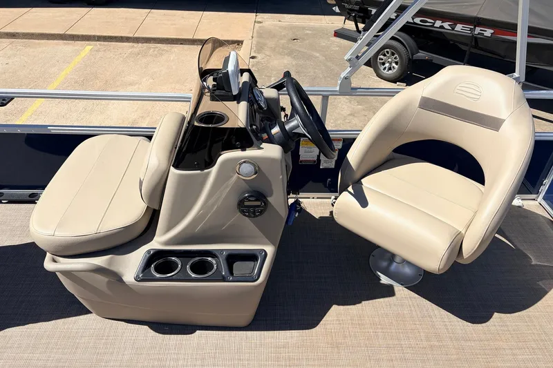 Slide: The Image of 2021 Sun Tracker Bass Buggy 16 XL boat interior with beige seating and steering console. - 25