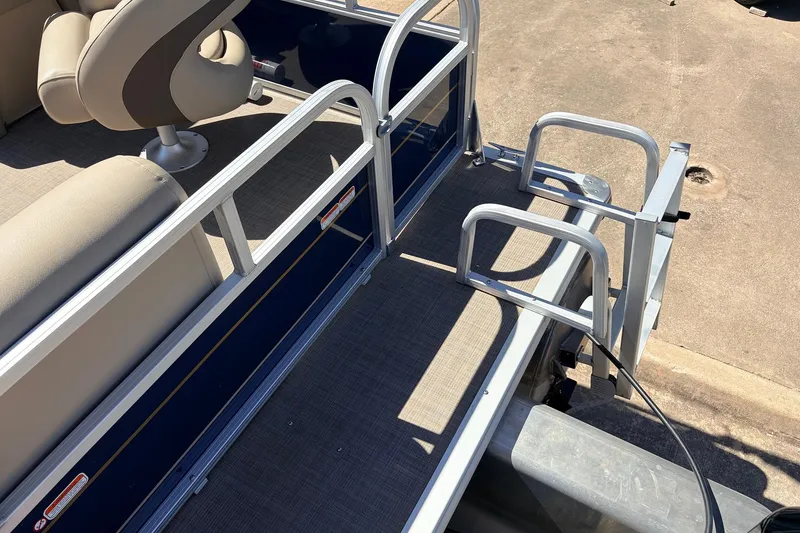 Slide: The Image of 2021 Sun Tracker Bass Buggy 16 XL pontoon boat interior with seating and railing. - 30