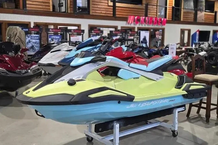 The Image of 2025 Yamaha WaveRunner JetBlaster PRO 3-Up displayed in a showroom with other models. - 0