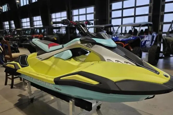 Slide: The Image of 2025 Yamaha WaveRunner JetBlaster PRO 3-Up in showroom, vibrant yellow and blue design. - 10