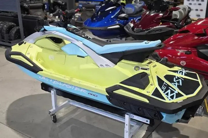 Slide: The Image of 2025 Yamaha WaveRunner JetBlaster PRO 3-Up in showroom, vibrant yellow and blue design. - 4