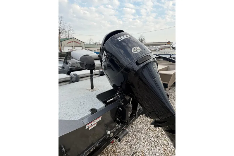 Slide: The Image of 2023 SeaArk 180 RX boat with a 90 HP outboard motor, parked outdoors. - 10