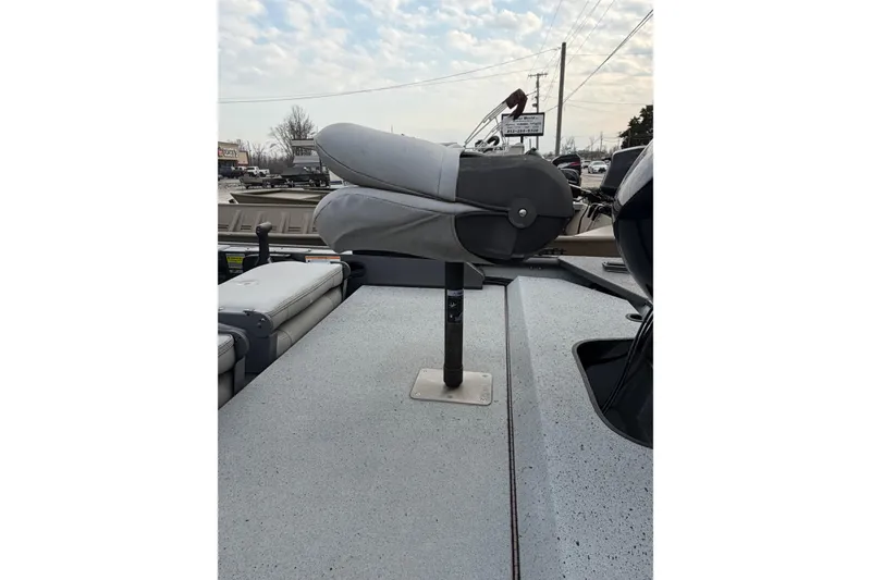 Slide: The Image of 2023 SeaArk 180 RX boat with folded seat on deck, under cloudy sky. - 12