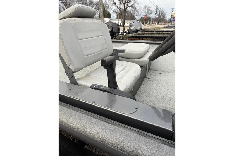 Slide: The Image of 2023 SeaArk 180 RX boat interior with gray seating and steering wheel. - 4