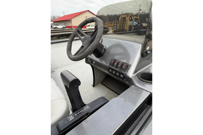 Slide: The Image of 2023 SeaArk 180 RX boat dashboard with steering wheel and control panel. - 5