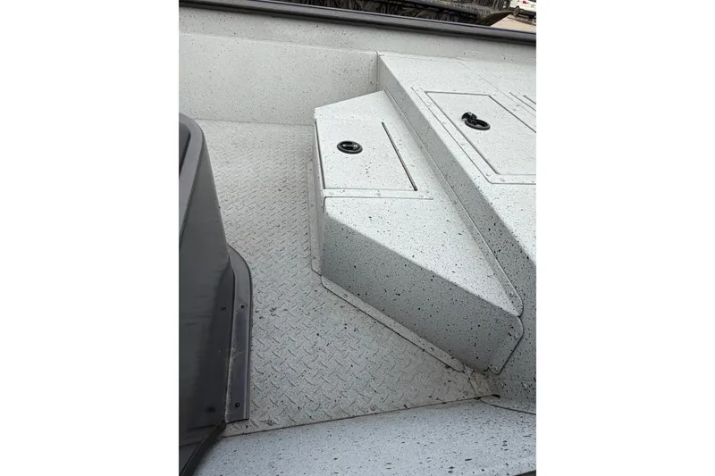 Slide: The Image of 2023 SeaArk 180 RX boat interior with textured flooring and storage compartments. - 7