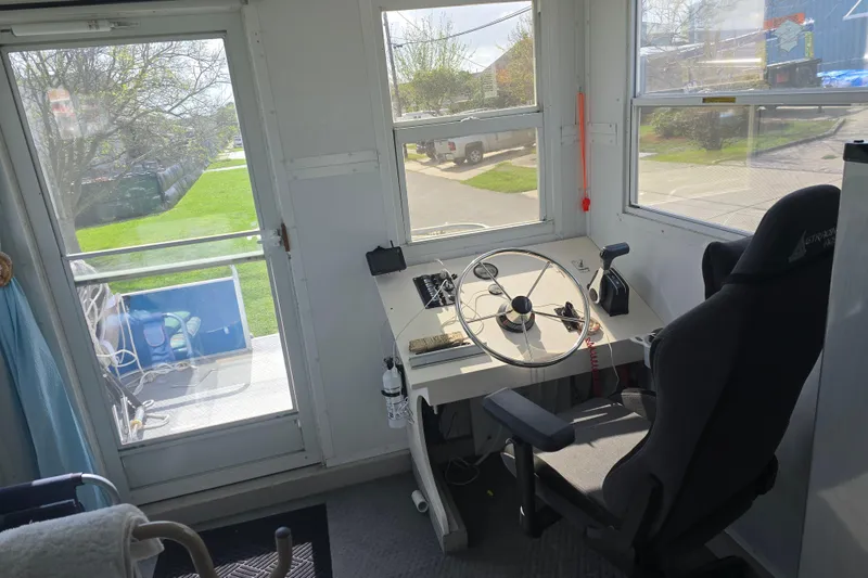 Slide: The Image of Control room of a 2003 Godfrey 24 boat with steering wheel and captain's chair. - 5