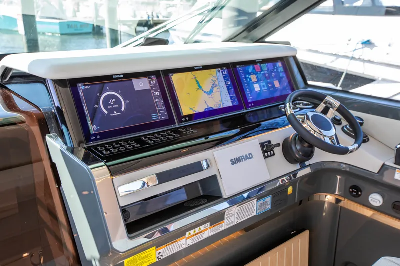 Slide: The Image of The image shows the modern cockpit of a Saxdor 400 GTC with multiple Simrad displays and a sleek steering wheel. - 49