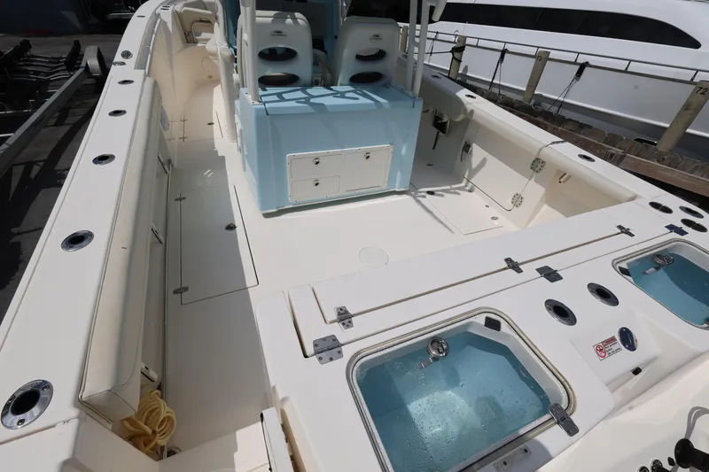Slide: The Image of 2019 Cobia 320 Center Console boat interior with seating and storage compartments. - 10