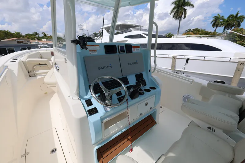Slide: The Image of 2019 Cobia 320 Center Console boat interior with Garmin navigation system. - 12