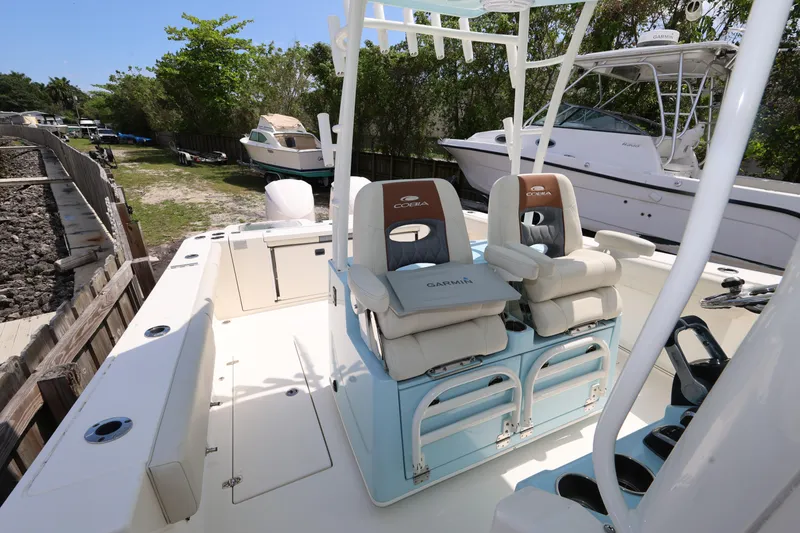 Slide: The Image of 2019 Cobia 320 Center Console boat with dual seating and Garmin equipment. - 22