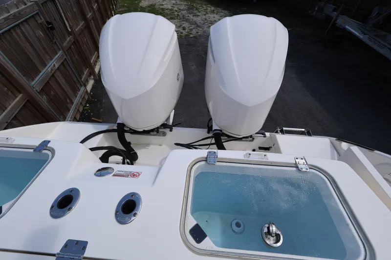Slide: The Image of 2019 Cobia 320 Center Console with dual outboard engines and livewell. - 27