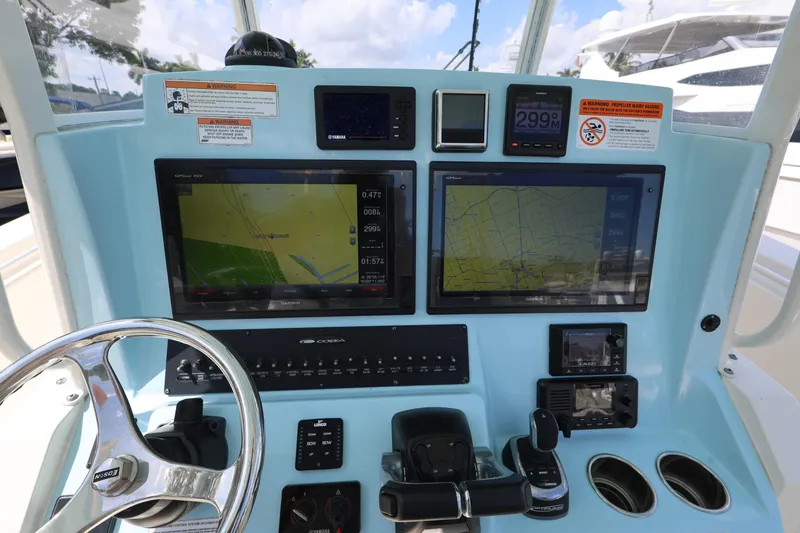 Slide: The Image of 2019 Cobia 320 Center Console dashboard with navigation screens and controls. - 28
