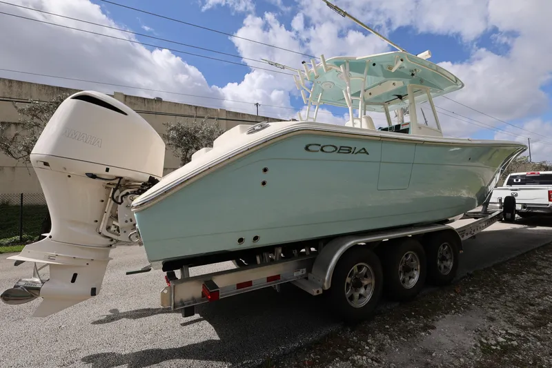 Slide: The Image of 2019 Cobia 320 Center Console boat on trailer with Yamaha outboard motor. - 7