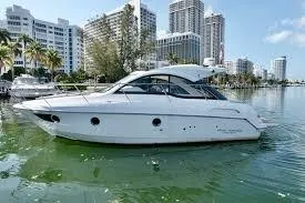 The Image of 2013 Beneteau Flyer GT 34 yacht on calm water with cityscape background. - 0