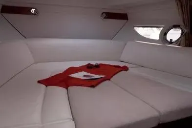 Slide: The Image of Interior of 2013 Beneteau Flyer GT 34 yacht with white cushioned seating. - 12