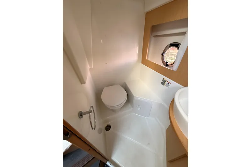 Slide: The Image of Interior of 2013 Beneteau Flyer GT 34, featuring wooden cabinetry and control panel. - 13