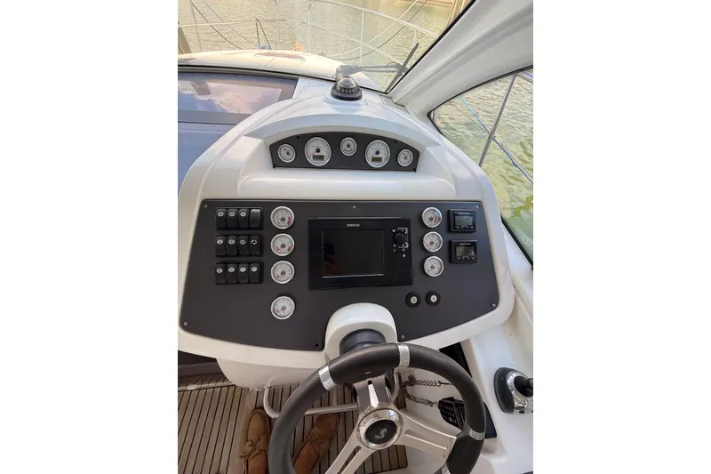 Slide: The Image of 2013 Beneteau Flyer GT 34 helm with steering wheel and control panel. - 3