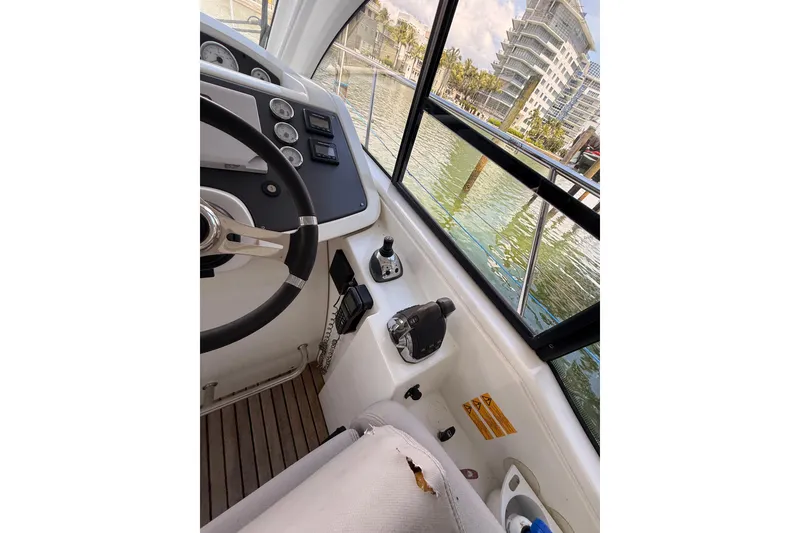 Slide: The Image of Interior view of 2013 Beneteau Flyer GT 34 boat cockpit with steering wheel and controls. - 5