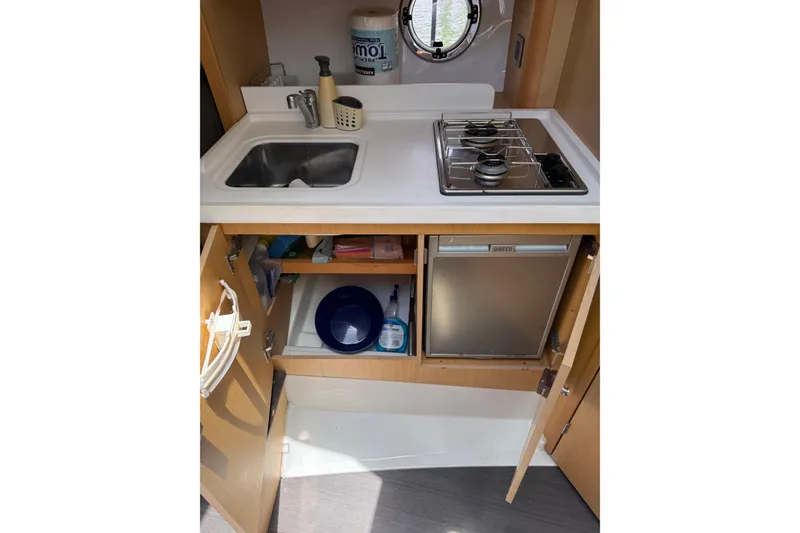 Slide: The Image of Compact kitchen area in 2013 Beneteau Flyer GT 34 with sink and two-burner stove. - 8