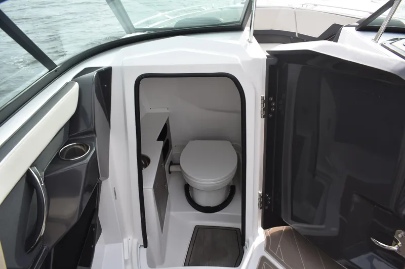 Slide: The Image of 2024 Monterey 255SS Super Sport boat interior with compact marine toilet. - 12
