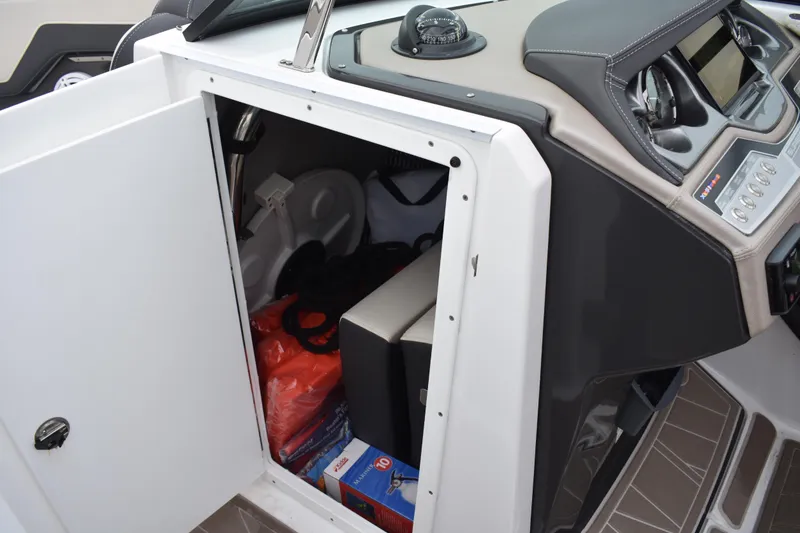 Slide: The Image of 2024 Monterey 255SS Super Sport boat storage compartment with various items inside. - 13