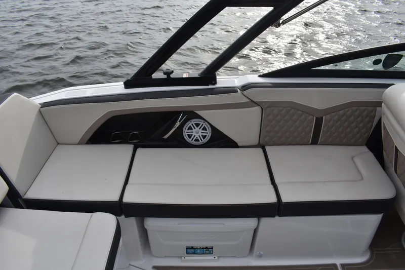 Slide: The Image of 2024 Monterey 255SS Super Sport boat interior with cushioned seating and speaker. - 16